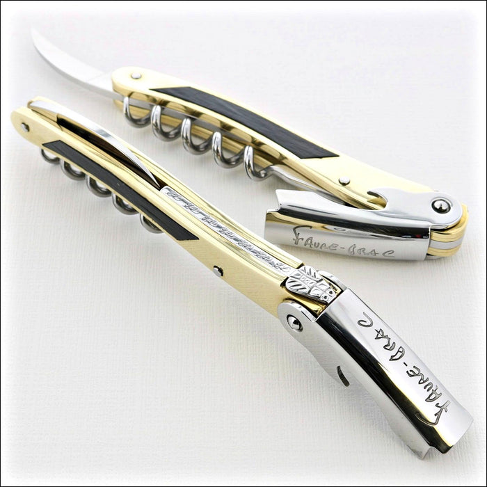 Chateau Laguiole Philippe Faure-Brac corkscrew, close-up of gold and black handle with "Faure-Brac" engraving. Handcrafted details, 100% Made in France.