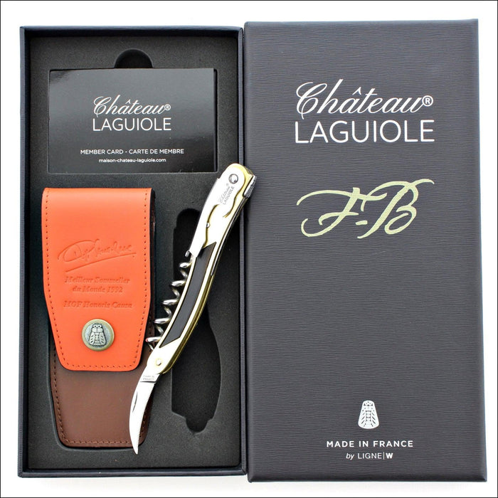 Chateau Laguiole Philippe Faure-Brac corkscrew, gold and black handle, with a brown leather pouch and member card in a gift box. Handcrafted details, 100% Made in France.