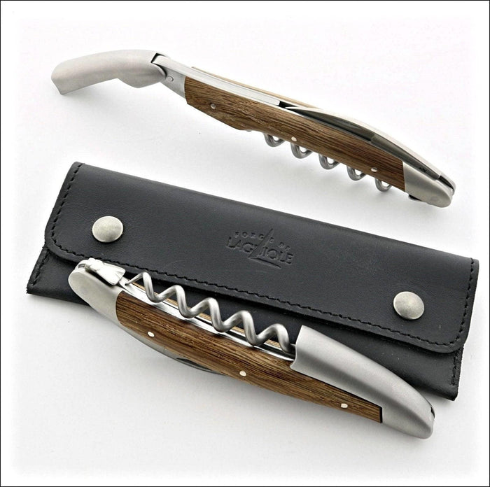 Forge de Laguiole Corkscrew, high-angle view of sub-fossilized oak handle and satin steel on leather.