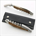 Forge de Laguiole Corkscrew, high-angle view of sub-fossilized oak handle and satin steel on leather.