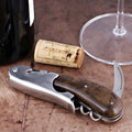 Laguiole Magnum Walnut Corkscrew close-up featuring a polished steel body and dark wood handle.