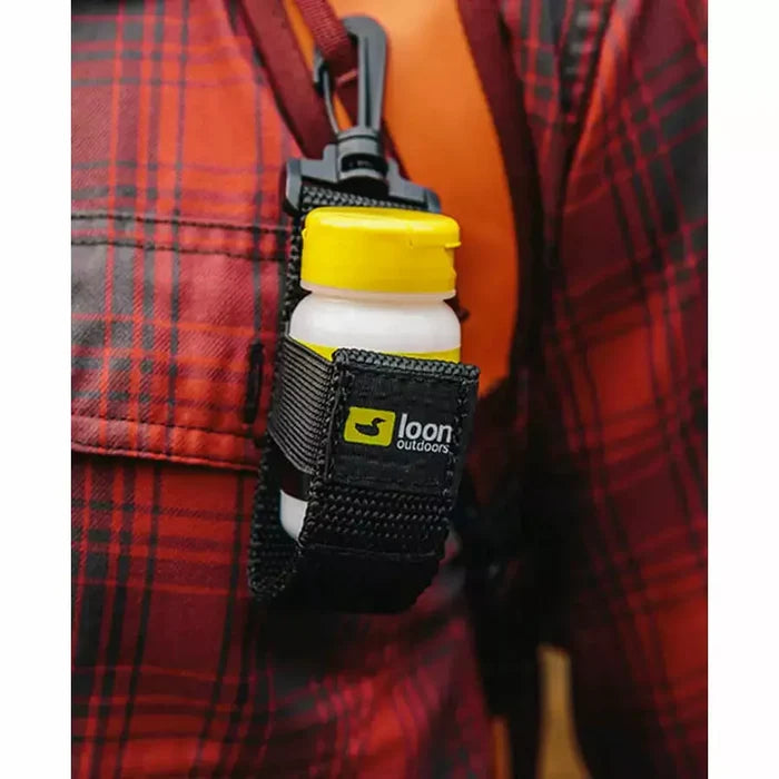 Loon caddy clipped to orange vest strap securing bottle