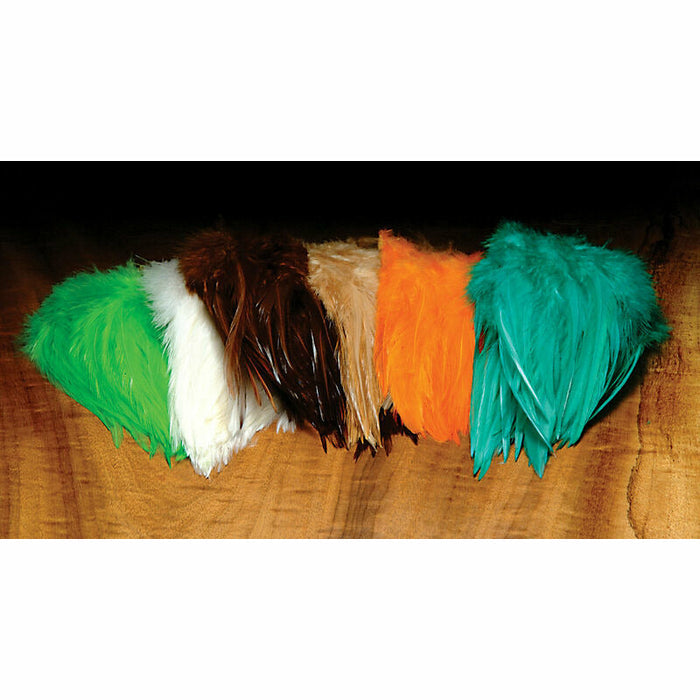 Assorted color saddle hackle bunches on wood table
